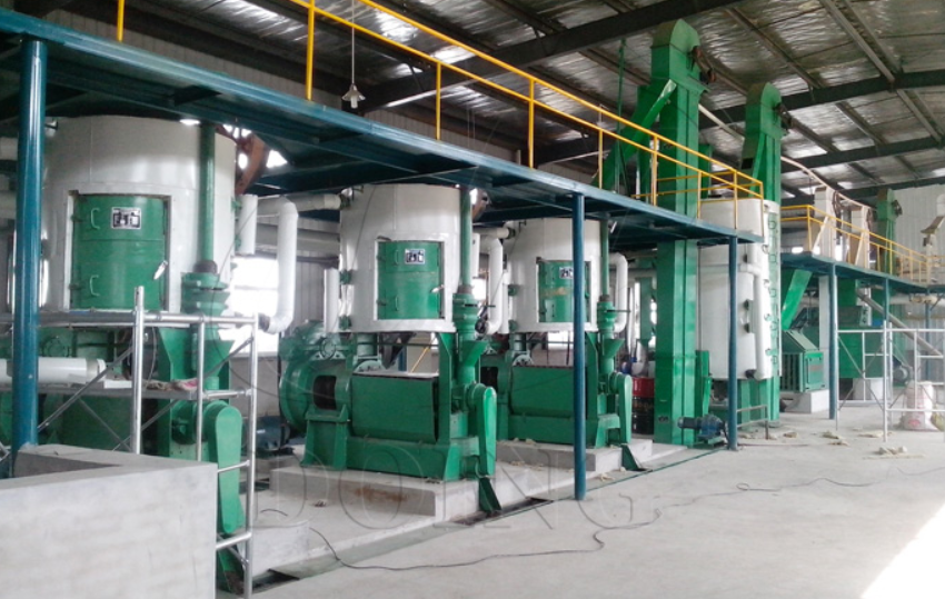 Modern oil processing facility with industrial equipment, workers in safety gear, and organized production line environment